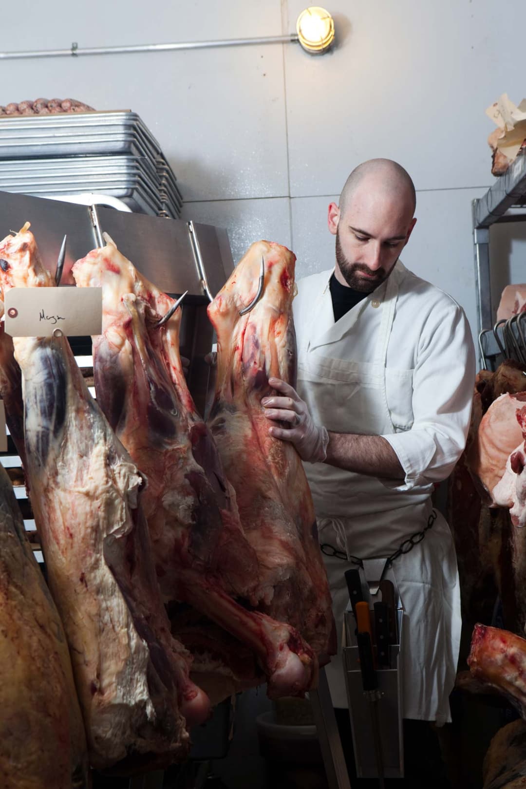 Butcher hanging beef